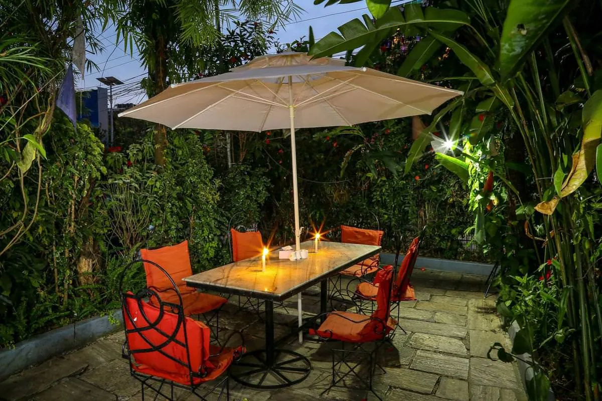 Candlelit table under a parasol in the garden